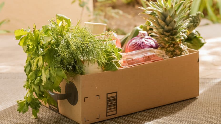 image: cardboard box full of fruits and vegetables 

image to illustrate popular online business model subscription boxes 