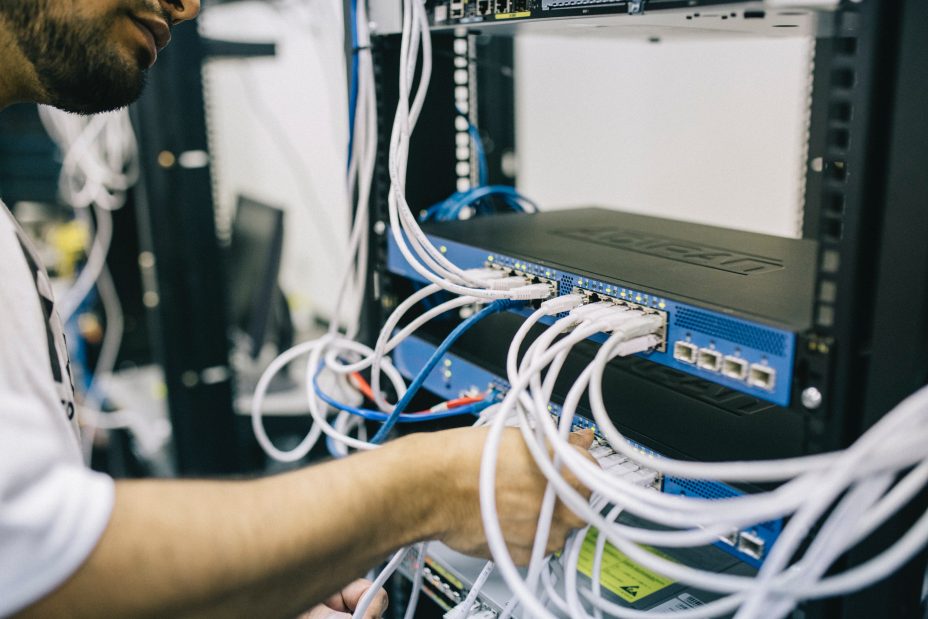 improve site speed by improving server response time 
Image: picture of man adjusting cables in a computer server 